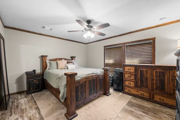 a bedroom with a bed and a chandelier