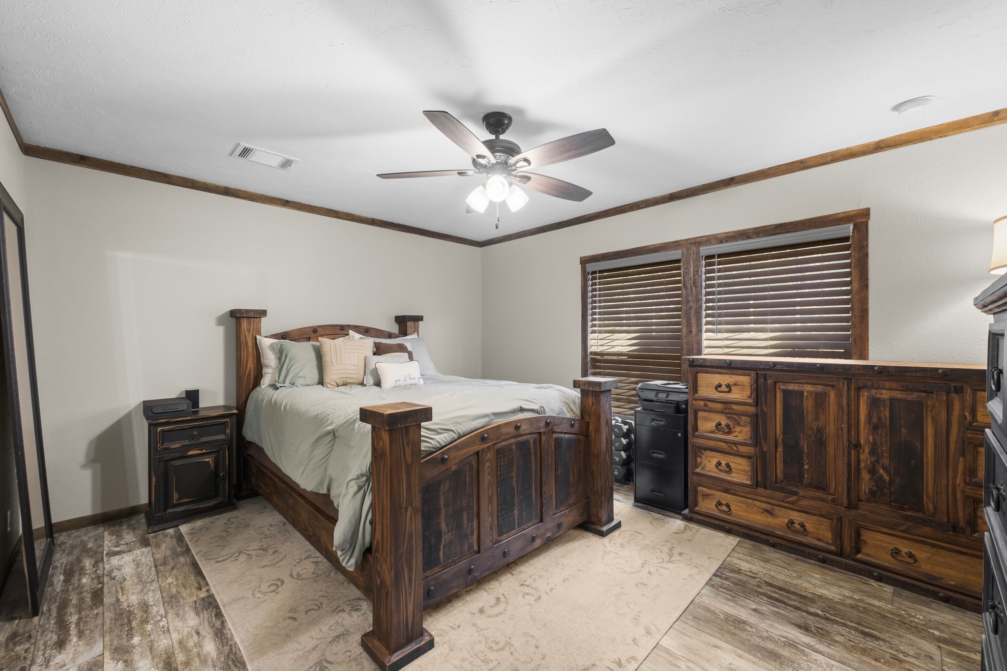 577 Winding River Road South Oakhurst, TX 77359 - Photo 15 of 31 a bedroom with a bed and a chandelier