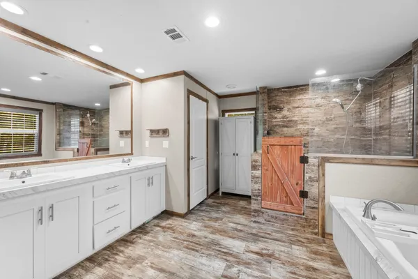 a bathroom with a double vanity sink and a mirror