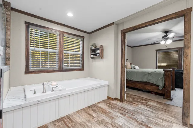 a spacious bedroom with a bed and a window