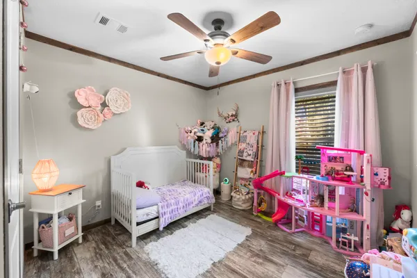 a bedroom with a bed and a chandelier