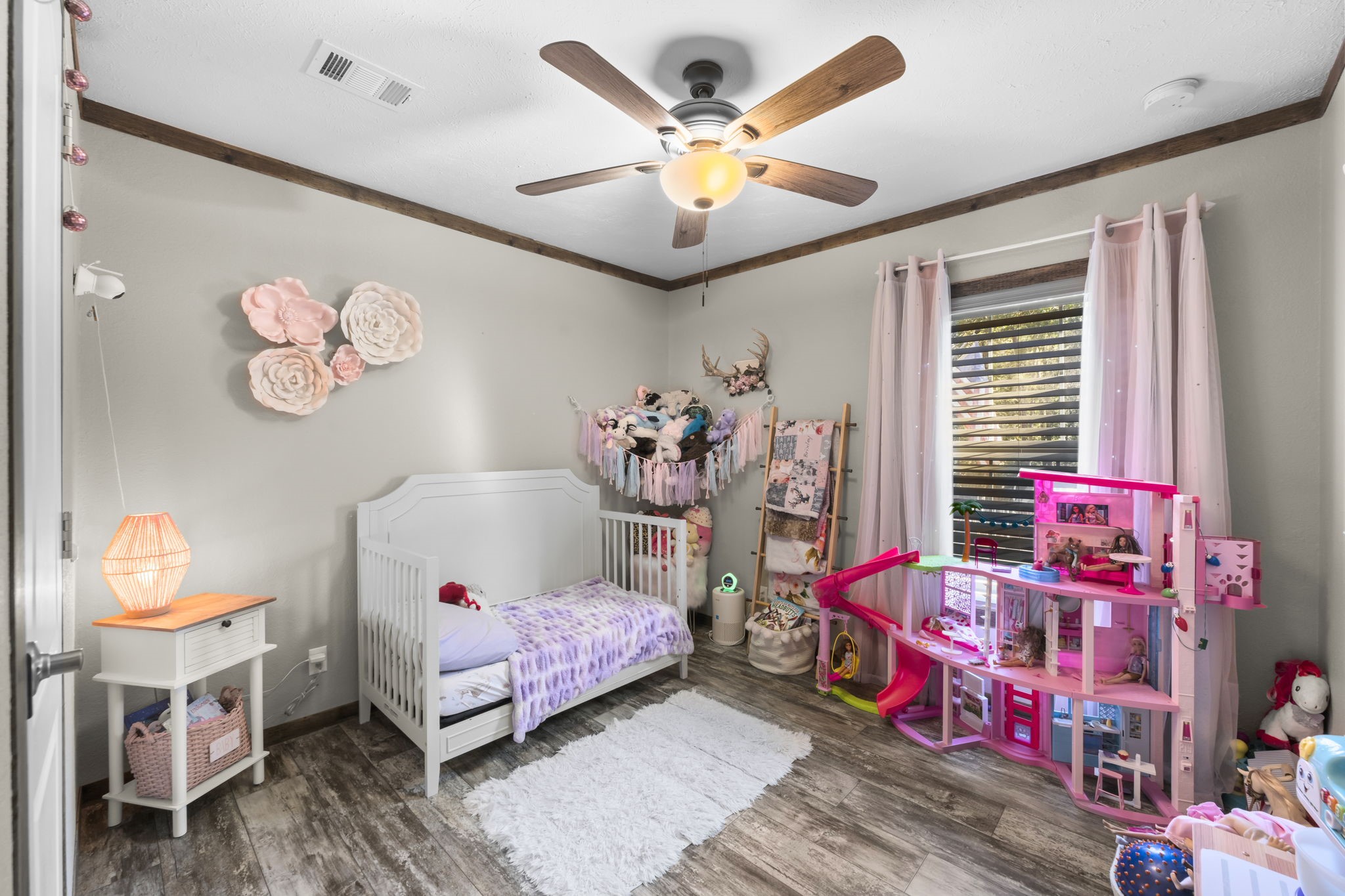 577 Winding River Road South Oakhurst, TX 77359 - Photo 23 of 31 a bedroom with a bed and a chandelier