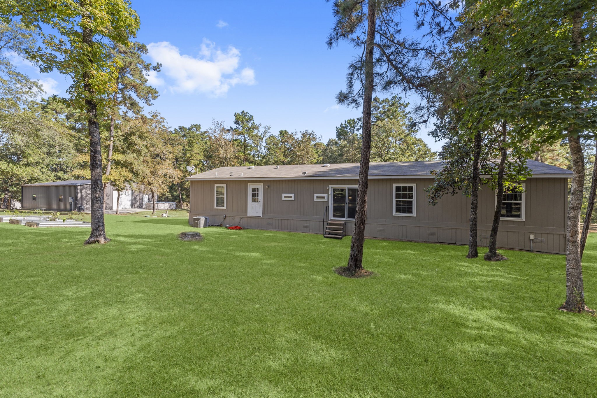 577 Winding River Road South Oakhurst, TX 77359 - Photo 25 of 31 a view of a house with a yard