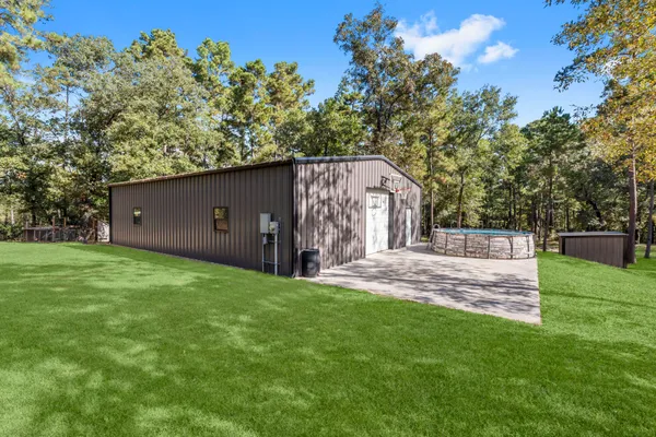 a view of a backyard with a garden and tree