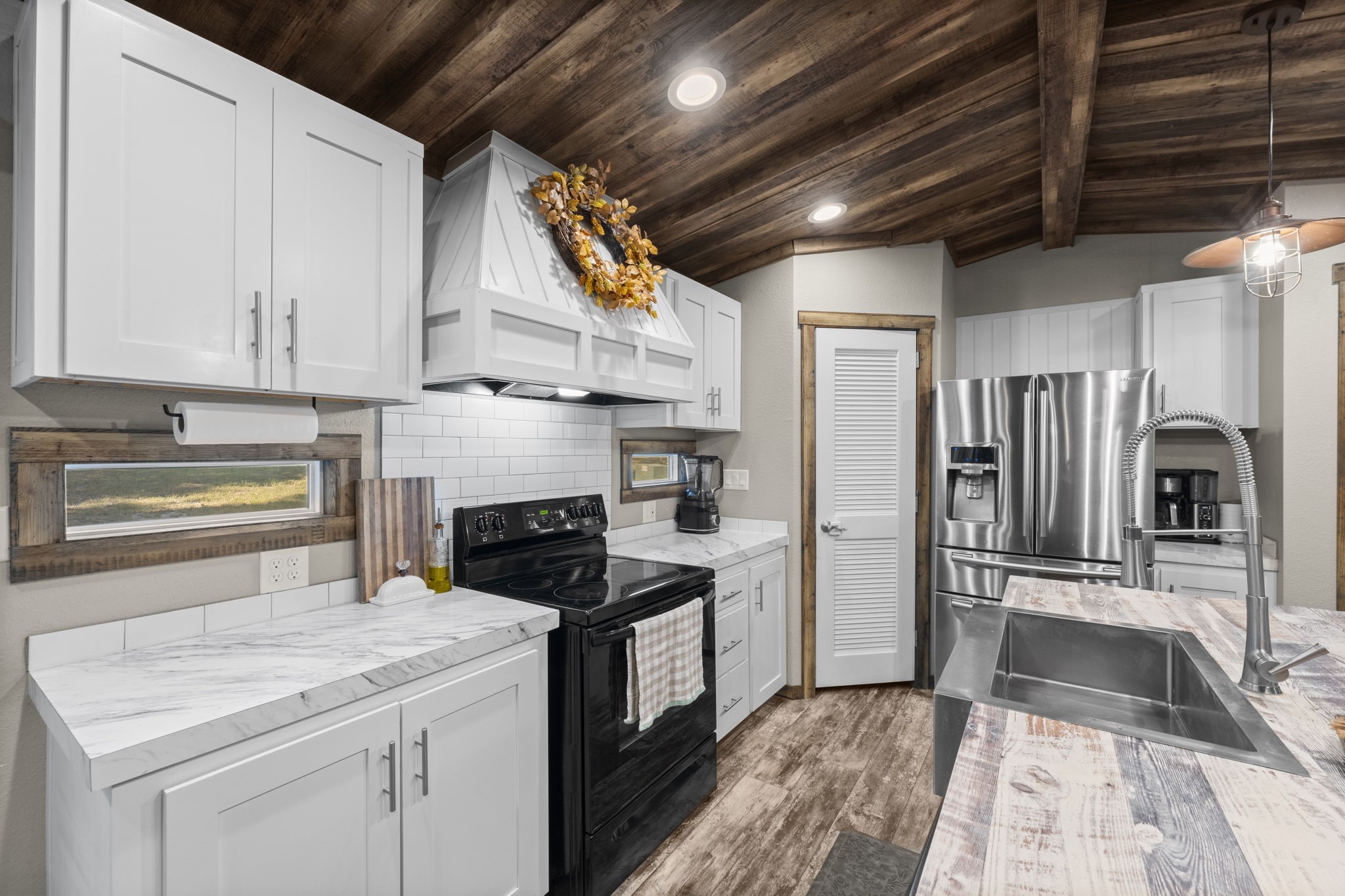 577 Winding River Road South Oakhurst, TX 77359 - Photo 9 of 31 a kitchen with refrigerator cabinets and a counter top space