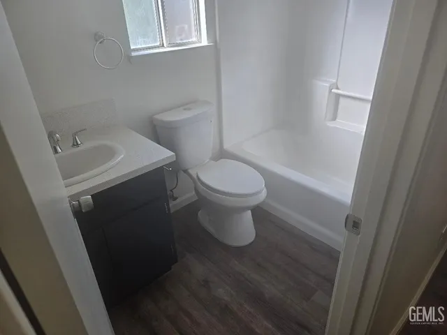 a white toilet sitting next to a bathroom sink