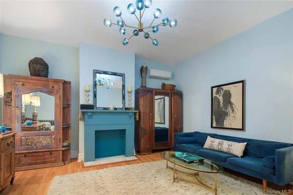 a living room with furniture and a chandelier