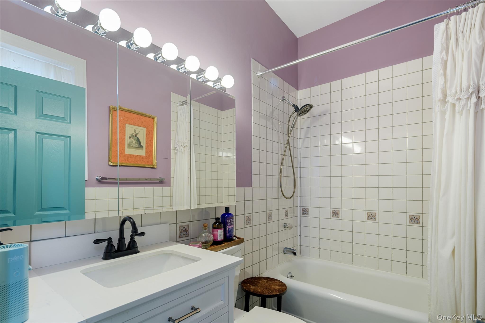 200 Nelson Avenue Peekskill, NY 10566 - Photo 19 of 41 Full bathroom with storage vanity, full tub with rolled edge, tile surround with decorative tile insets