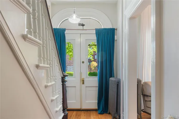 a view of an entryway with wooden floor