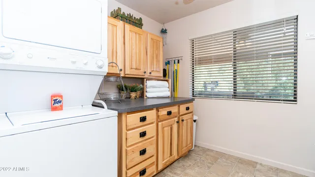 a en suite bathroom with a granite countertop sink and a mirror