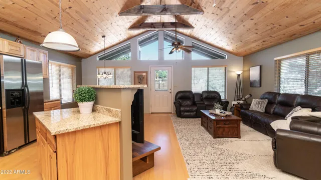 a kitchen with stainless steel appliances granite countertop a sink a stove and a wooden floors