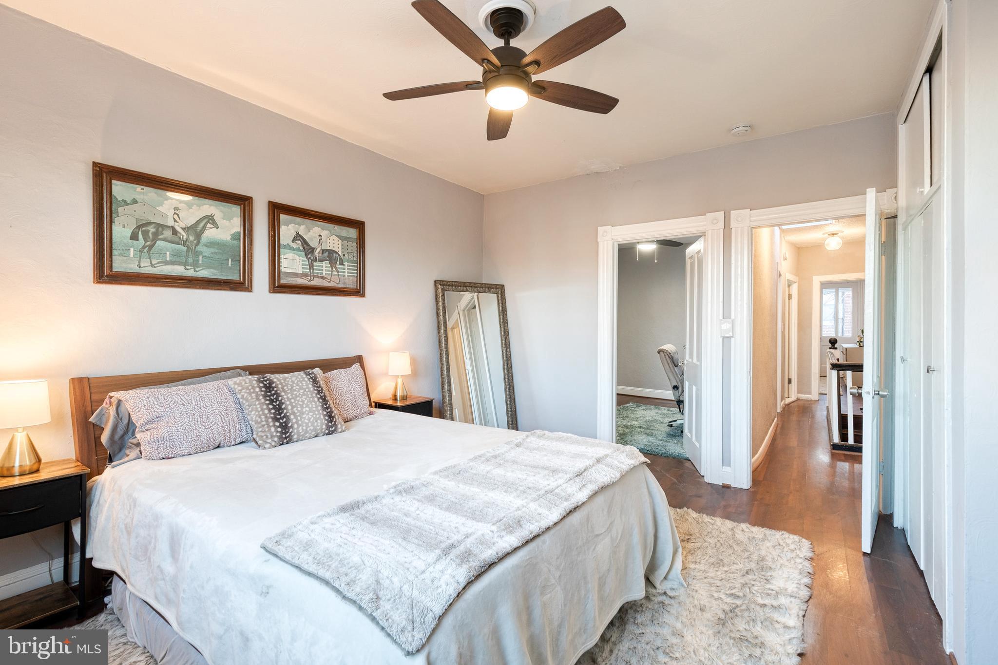 3903 Hudson Street Baltimore, MD 21224 - Photo 18 of 34 a bedroom with a large bed and a chandelier