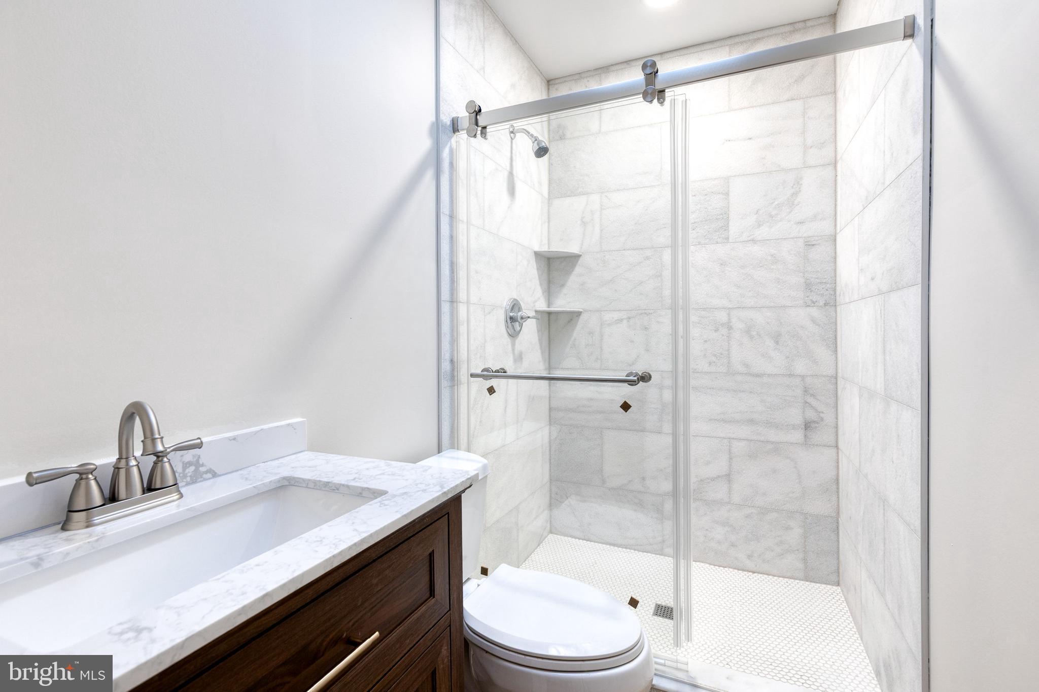 3903 Hudson Street Baltimore, MD 21224 - Photo 25 of 34 a bathroom with a granite countertop sink toilet and shower