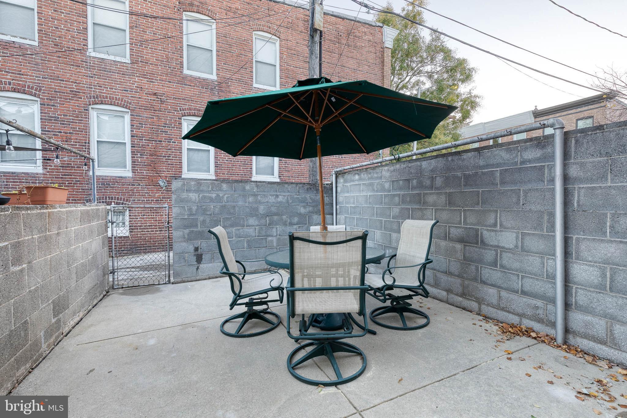 3903 Hudson Street Baltimore, MD 21224 - Photo 29 of 34 a table and chair under an umbrella