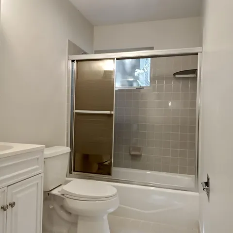 a bathroom with a shower a toilet and a shower