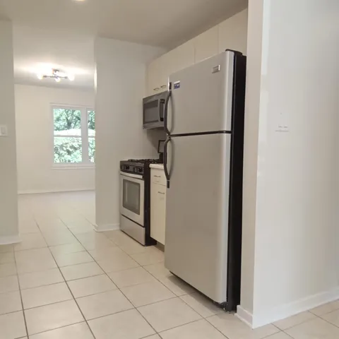 a view of a kitchen with a refrigerator washer and dryer