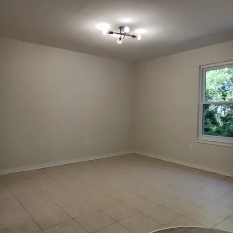 an empty room with a empty space and windows