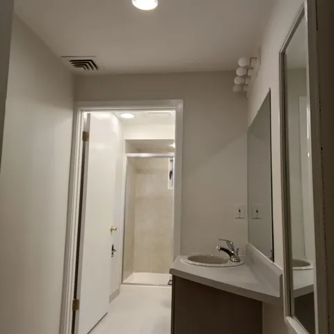 a bathroom with a sink and mirror