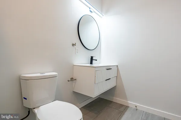 a bathroom with a toilet a sink and a mirror