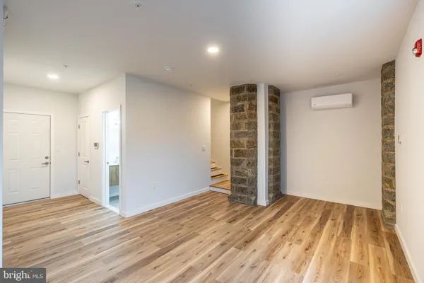 an empty room with wooden floor and closet