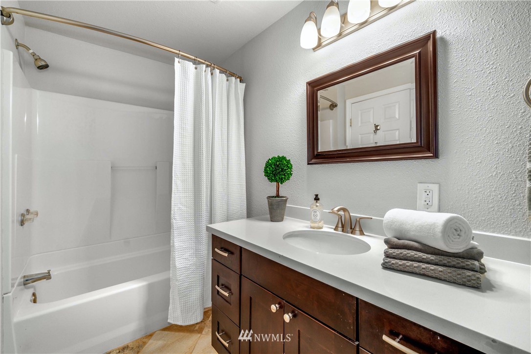 750 South 25th Street Renton, WA 98055 - Photo 14 of 37 a bathroom with a sink vanity granite tub and shower