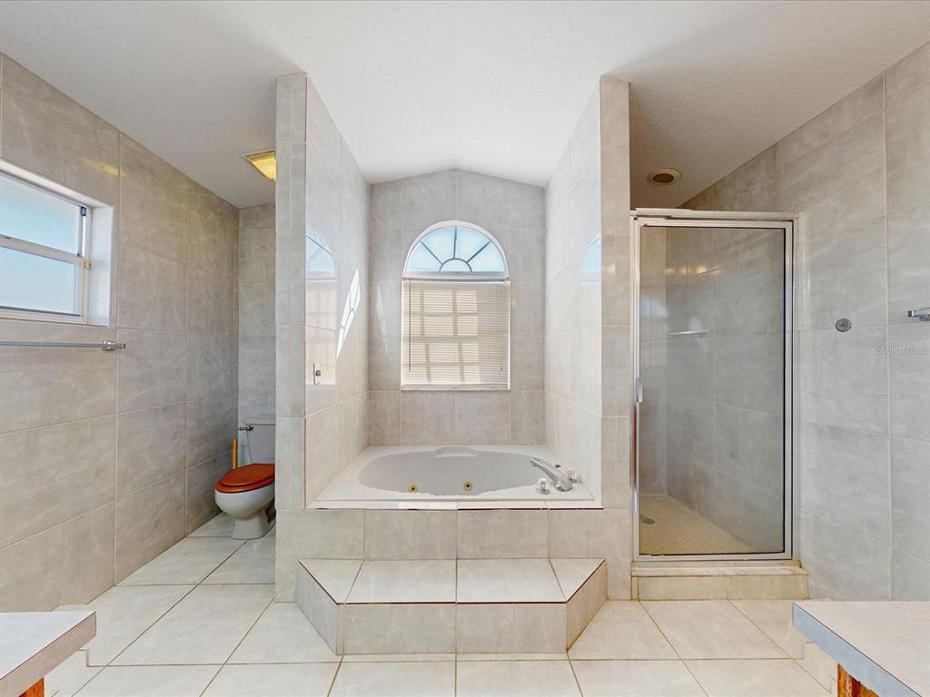 978 Alsace Drive Kissimmee, FL 34759 - Photo 7 of 30 a bathroom with a tub and shower