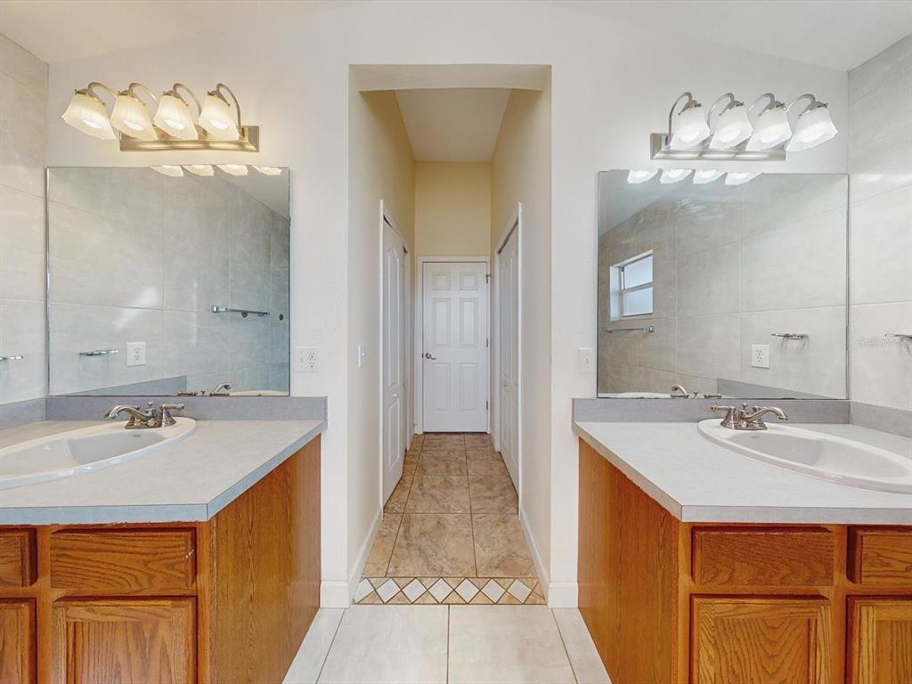 978 Alsace Drive Kissimmee, FL 34759 - Photo 8 of 30 a bathroom with a sink and a mirror