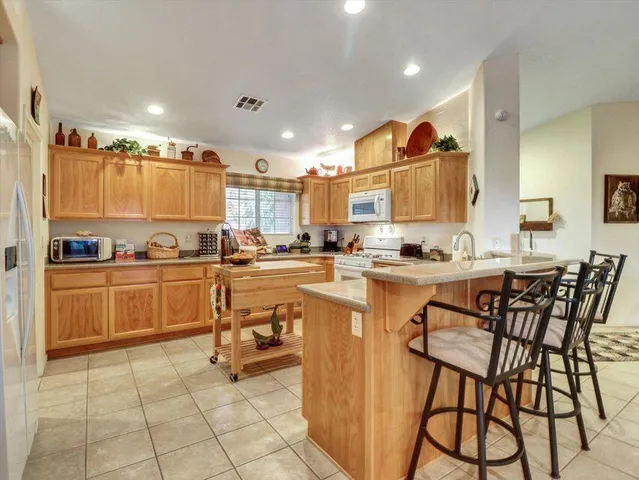 a view of a dining room with furniture and a potted plant