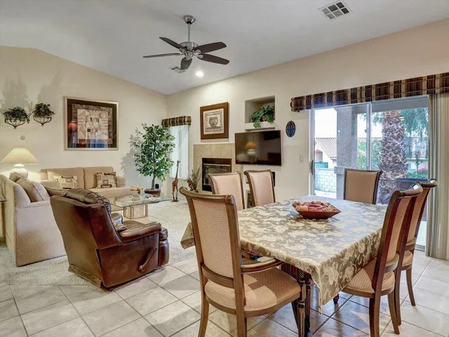 a living room with furniture a dining table and chairs with kitchen view
