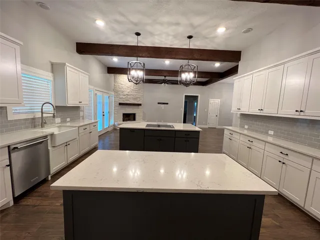 a large kitchen with kitchen island a sink stainless steel appliances and cabinets