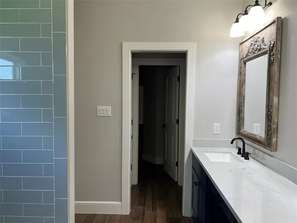 a bathroom with a double vanity sink a mirror and a bathtub