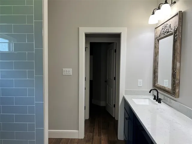a bathroom with a double vanity sink a mirror and a bathtub