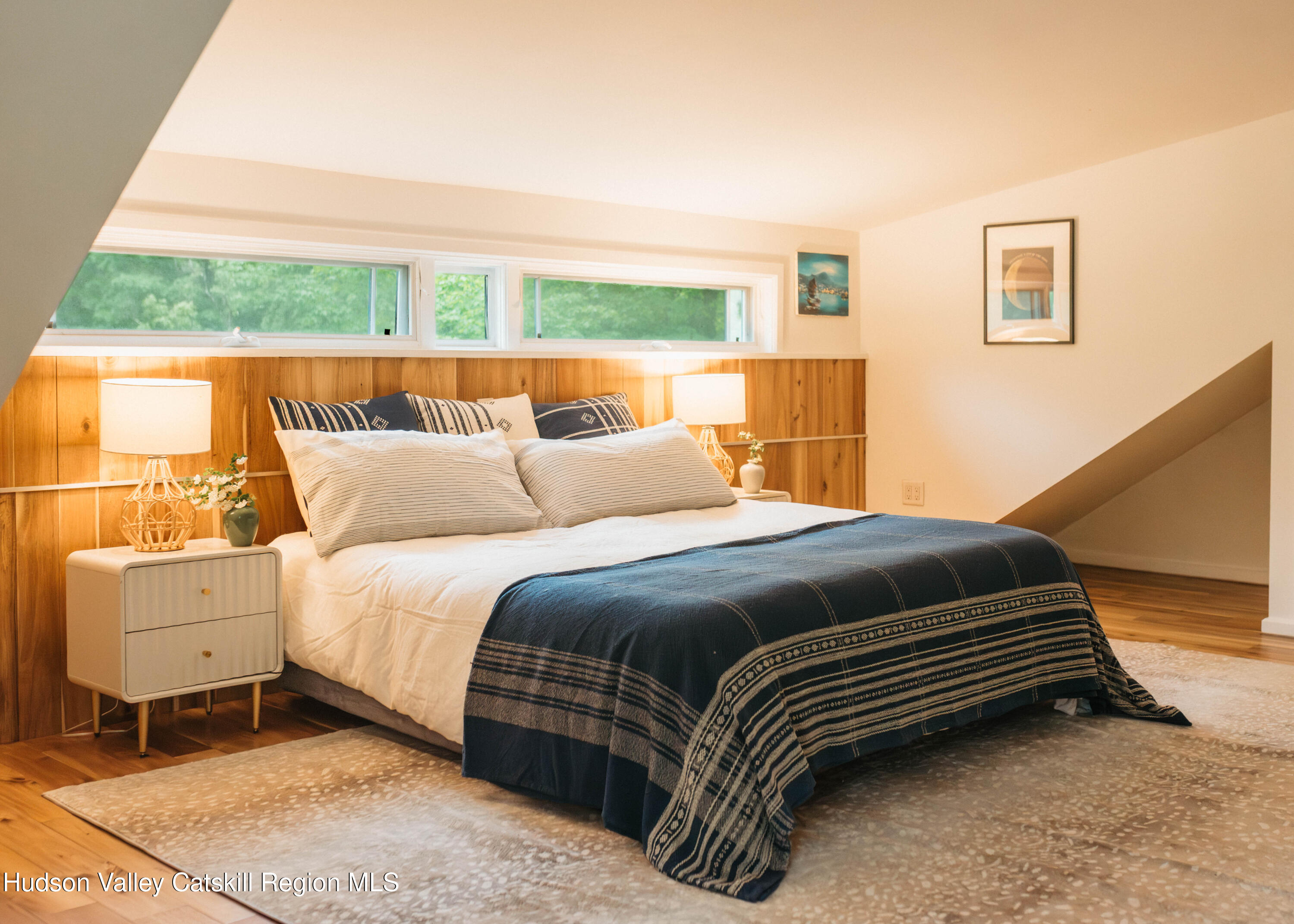 675 Cooper Lake Road Woodstock, NY 12448 - Photo 18 of 31 a bedroom with a bed and wooden floor
