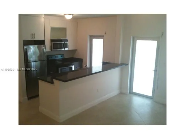 a kitchen with stainless steel appliances a refrigerator and a sink