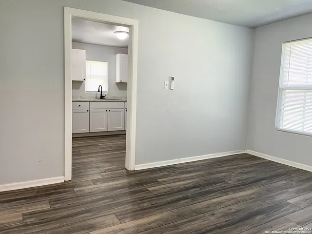 wooden floor in an empty room and a window