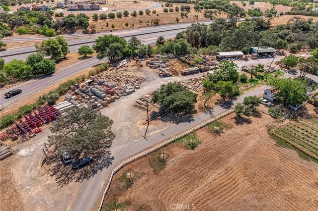 an aerial view of a house with a yard and lake view