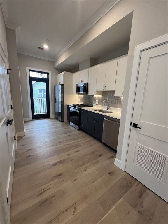 157 Everett Street, Unit 203 Boston, MA 02134 - Photo 8 of 11 a view of kitchen with wooden floor and window