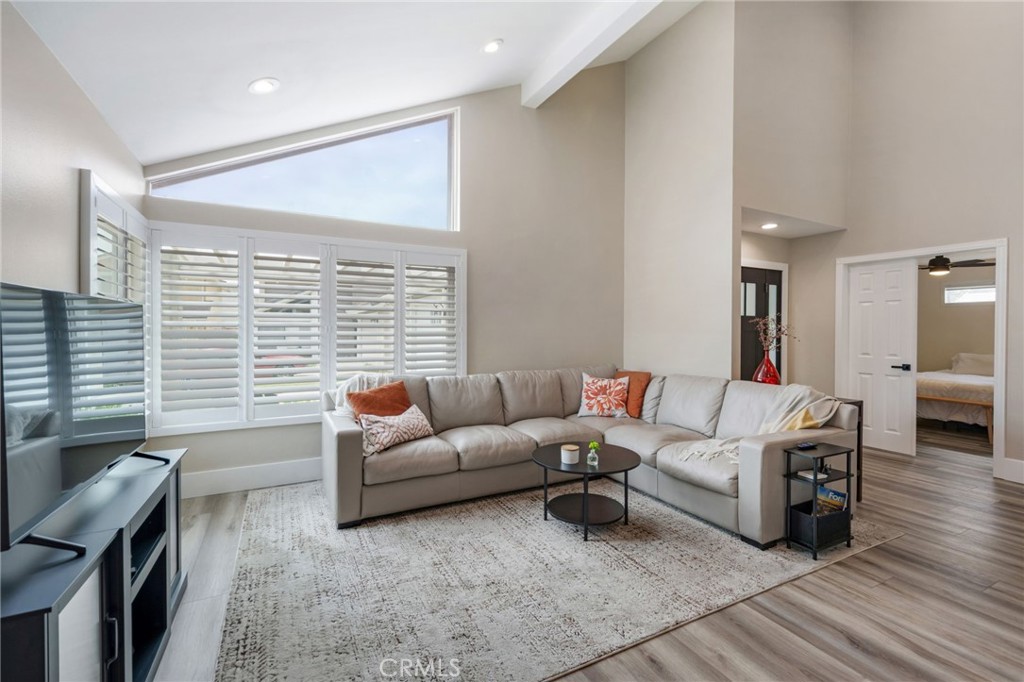 109 Cinnamon Ridge Road Brea, CA 92821 - Photo 12 of 67 Living room view from dining room area including vaulted ceiling, recessed lighting, plantation shutters, view of main entry and next to main entry is main floor bedroom.
