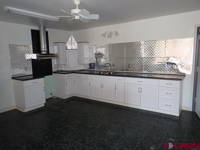 10944 Mesa View Loop Eckert, CO 81418 - Photo 2 of 10 a kitchen with granite countertop a sink stainless steel appliances and cabinets