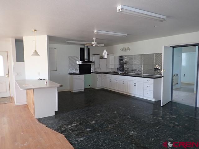 10944 Mesa View Loop Eckert, CO 81418 - Photo 3 of 10 a large kitchen with kitchen island a sink stainless steel appliances and cabinets