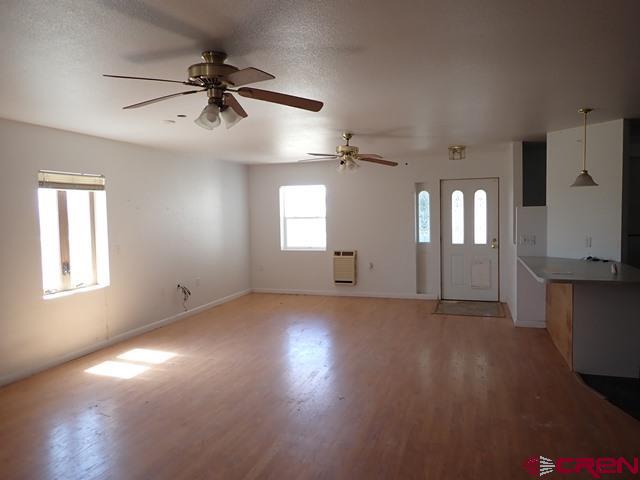 10944 Mesa View Loop Eckert, CO 81418 - Photo 4 of 10 a view of an empty room with a window and wooden floor