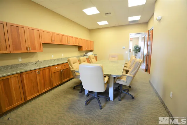a view of a kitchen with dining area and chandelier