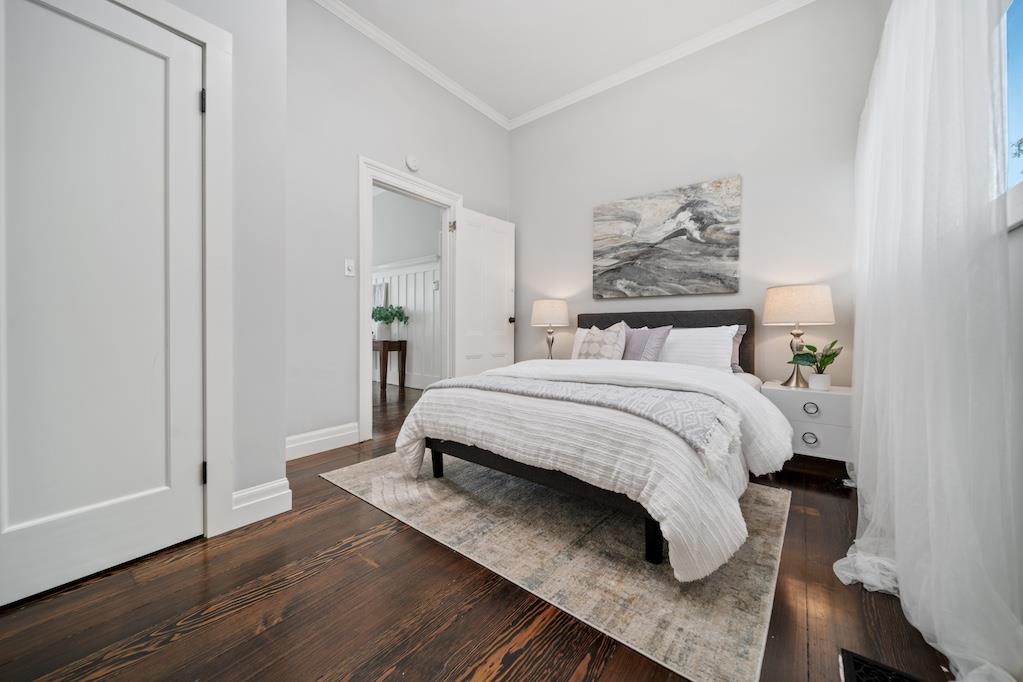 1731 11th Street Oakland, CA 94607 - Photo 13 of 35 a bedroom with a bed and wooden floor
