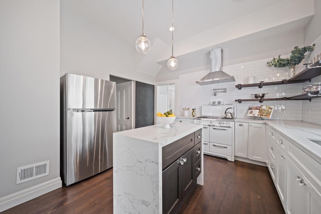 1731 11th Street Oakland, CA 94607 - Photo 17 of 35 a kitchen with refrigerator cabinets and wooden floor