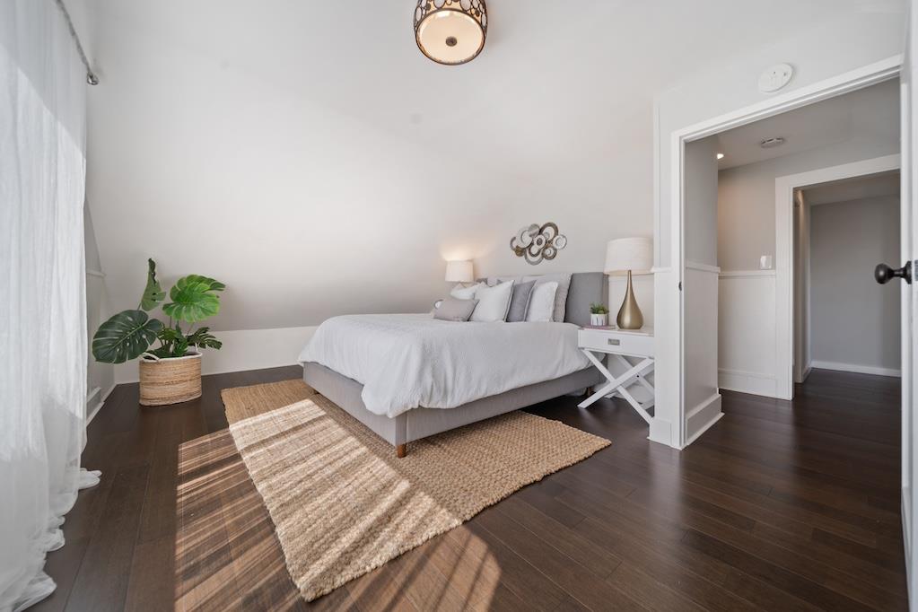 1731 11th Street Oakland, CA 94607 - Photo 25 of 35 a bedroom with a bed and a potted plant