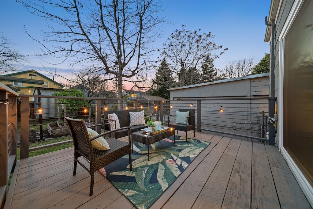 1731 11th Street Oakland, CA 94607 - Photo 31 of 35 a view of a chairs and table on the wooden floor in front of house