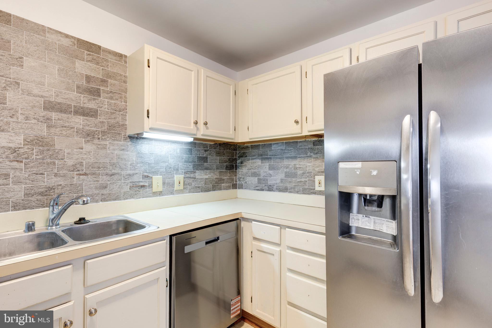 385 Pleasanton Road, Unit B22 Westminster, MD 21157 - Photo 11 of 35 a kitchen with a sink and refrigerator