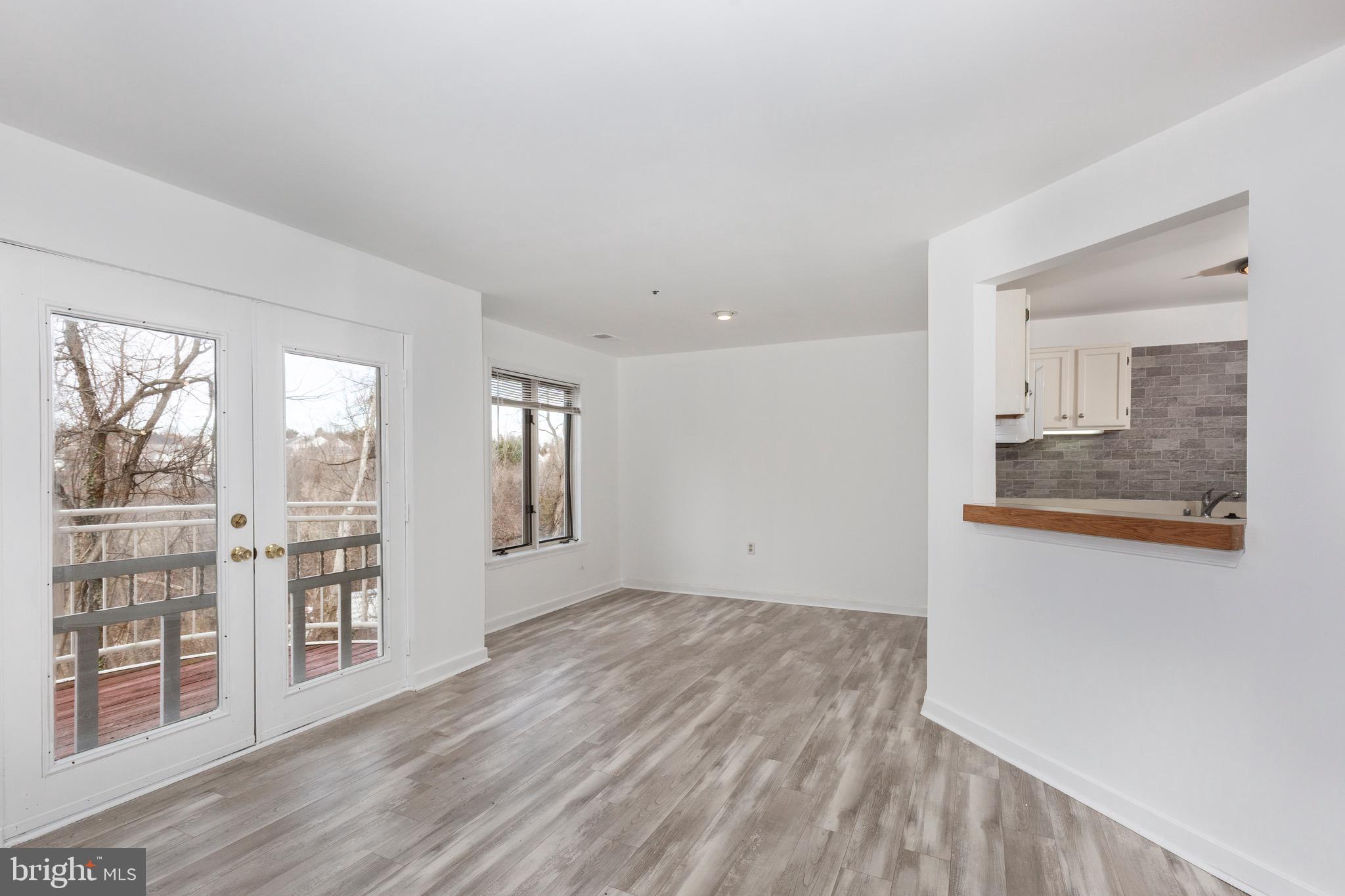 385 Pleasanton Road, Unit B22 Westminster, MD 21157 - Photo 16 of 35 wooden floor in an empty room with a window