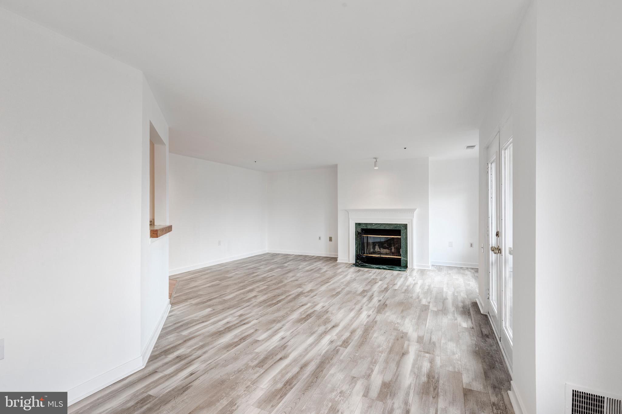 385 Pleasanton Road, Unit B22 Westminster, MD 21157 - Photo 18 of 35 a view of a livingroom with an empty space and a fireplace