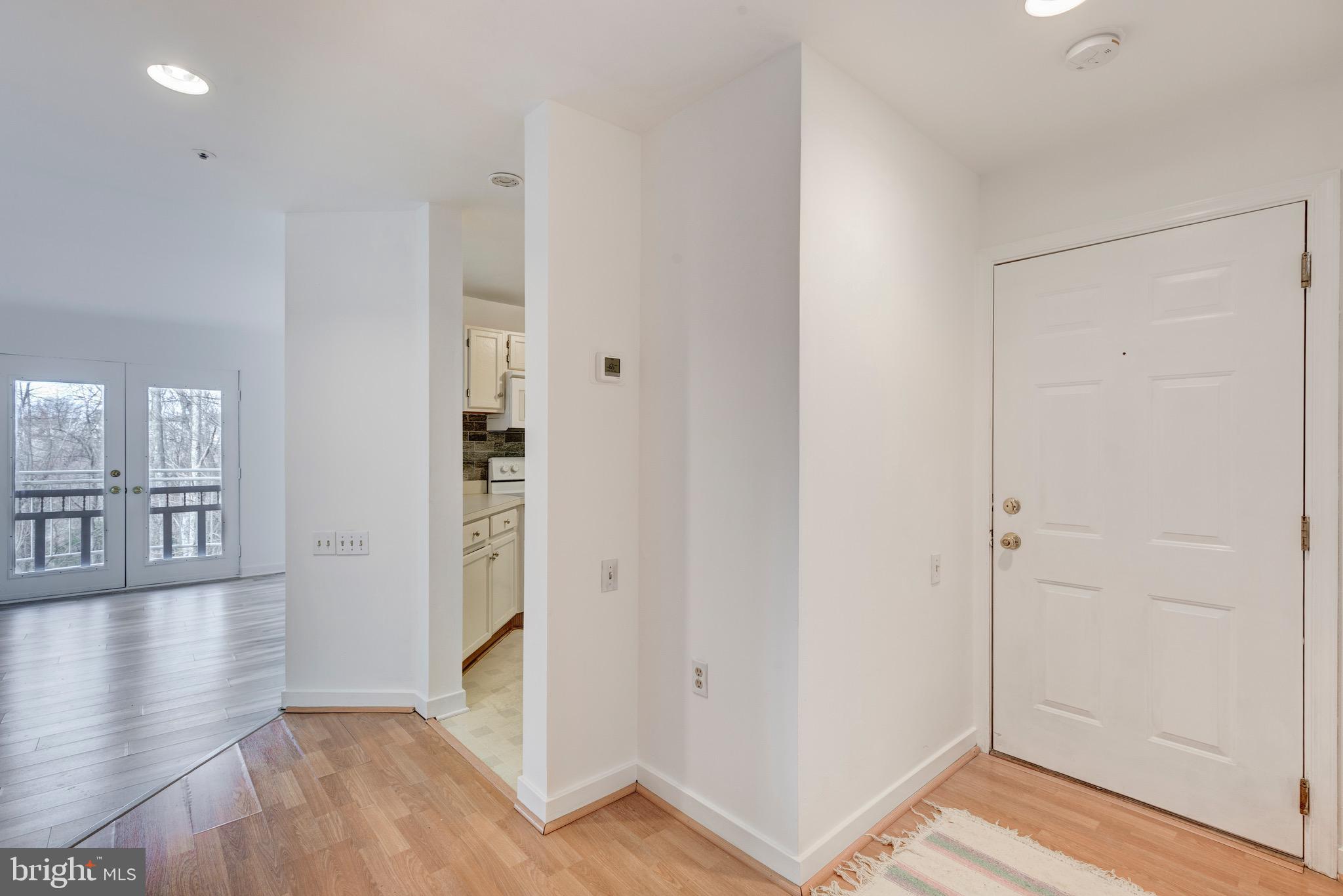 385 Pleasanton Road, Unit B22 Westminster, MD 21157 - Photo 5 of 35 a view of a hallway with wooden floor and entryway